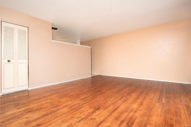 empty room with wood finished floors and baseboards