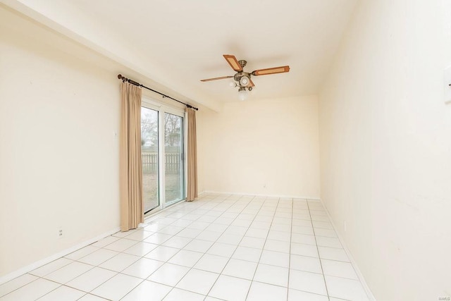 empty room featuring light tile patterned floors, ceiling fan, and baseboards