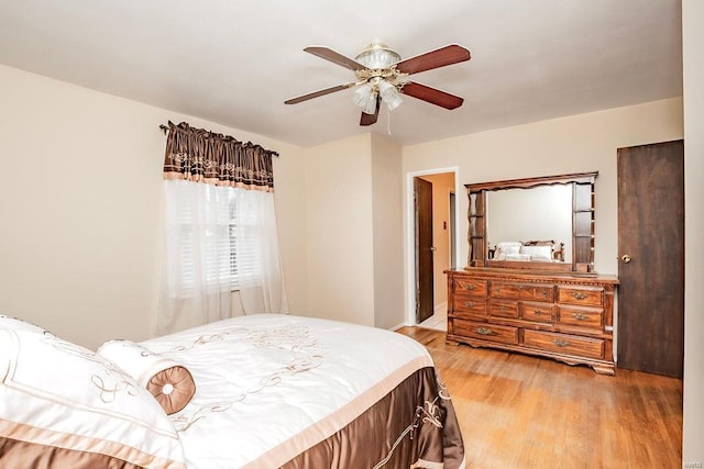 bedroom with light wood finished floors and a ceiling fan