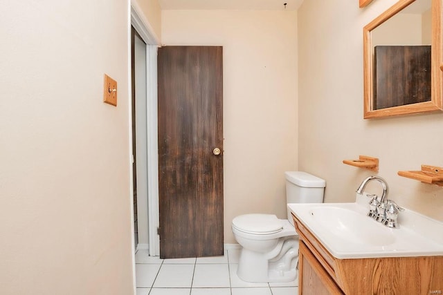 half bath featuring vanity, tile patterned flooring, and toilet