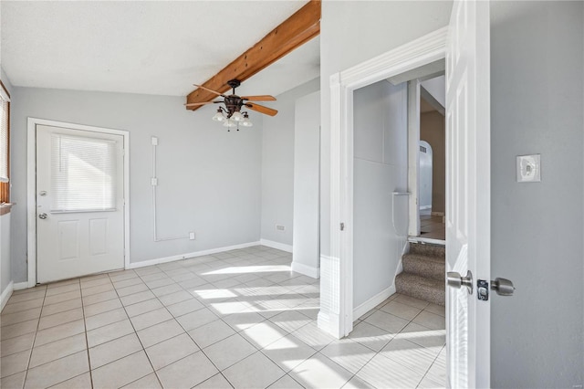 entryway featuring arched walkways, light tile patterned flooring, a ceiling fan, baseboards, and beam ceiling