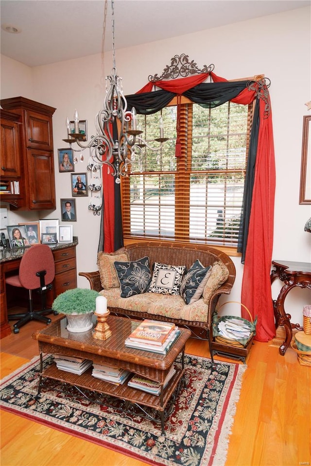 living room with wood finished floors and built in study area