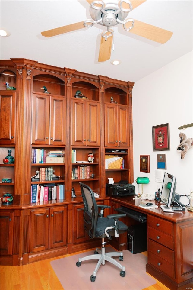 office with light wood finished floors and a ceiling fan