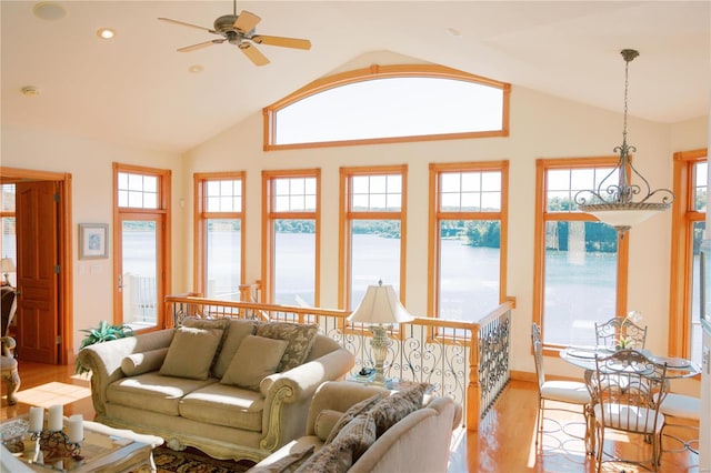 living area with light wood-style floors, ceiling fan, high vaulted ceiling, and recessed lighting