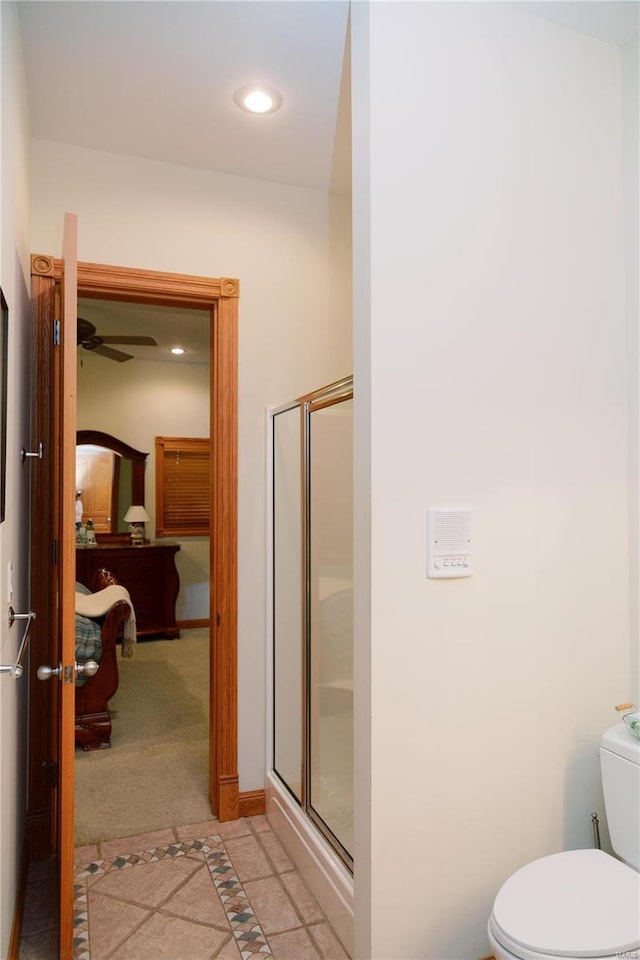 bathroom with toilet, a stall shower, tile patterned flooring, and recessed lighting