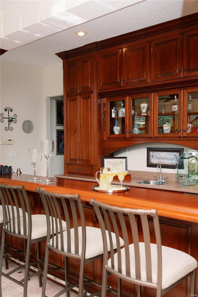 bar featuring indoor wet bar and a sink