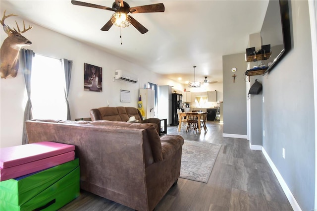 living room with ceiling fan, baseboards, dark wood-type flooring, and a wall mounted air conditioner