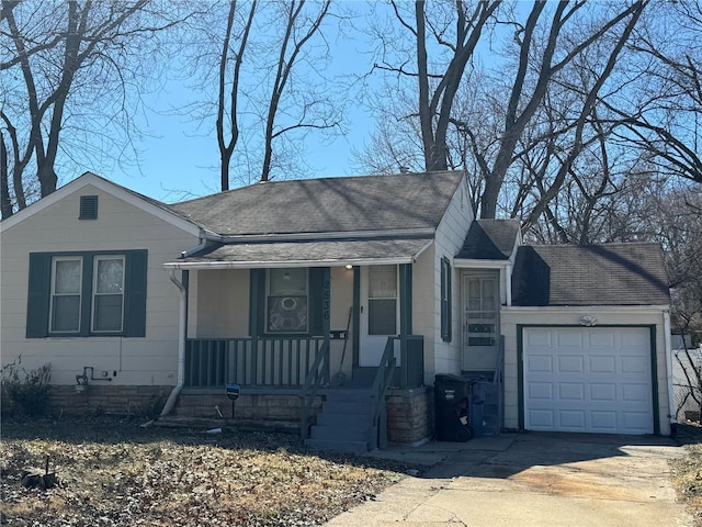 view of front facade with an attached garage, covered porch, concrete driveway, and roof with shingles