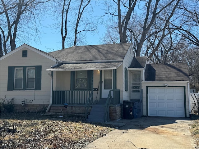 view of front of property with an attached garage, a shingled roof, a porch, and concrete driveway