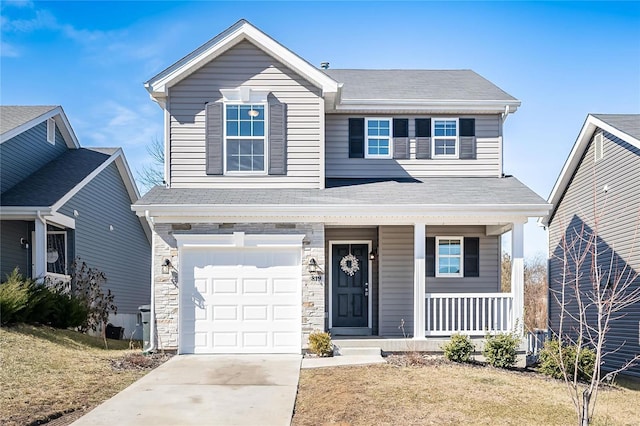 traditional-style home featuring driveway, stone siding, an attached garage, covered porch, and a front yard