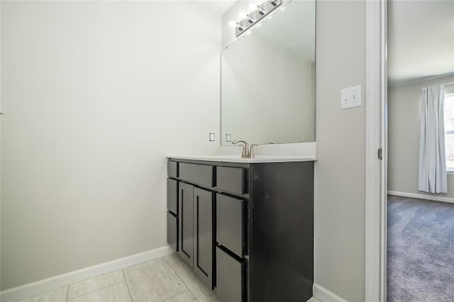 bathroom featuring baseboards and vanity