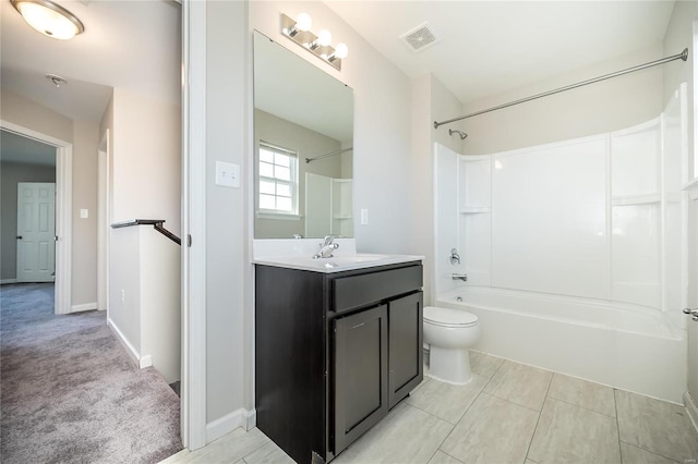 bathroom featuring toilet, vanity, visible vents, baseboards, and washtub / shower combination