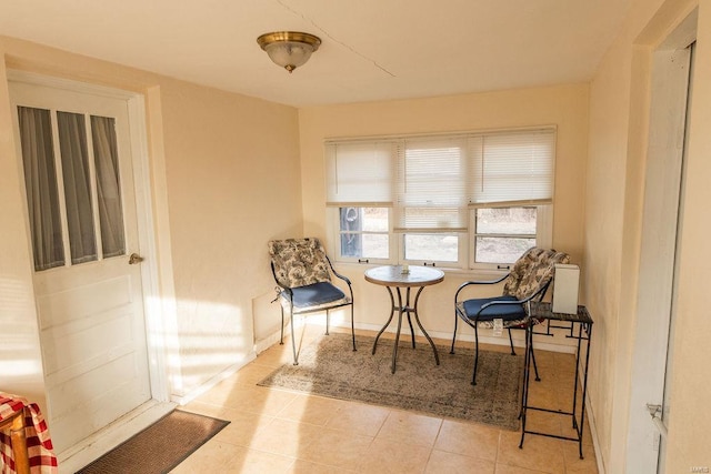 sitting room featuring baseboards and tile patterned floors