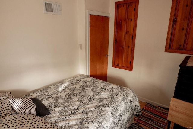 bedroom with visible vents and baseboards