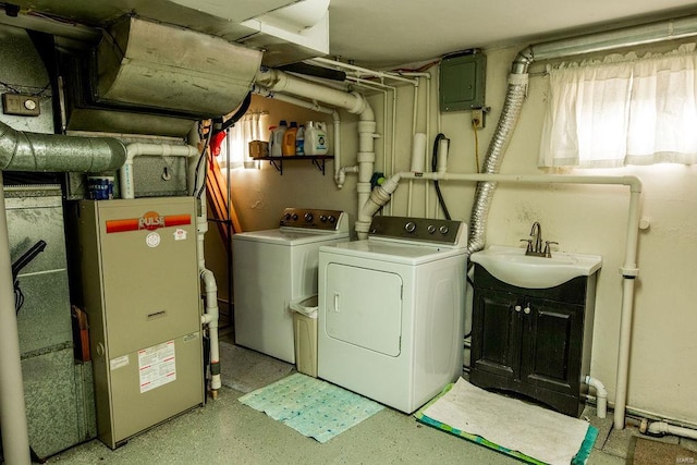 laundry area featuring laundry area, electric panel, a sink, and separate washer and dryer