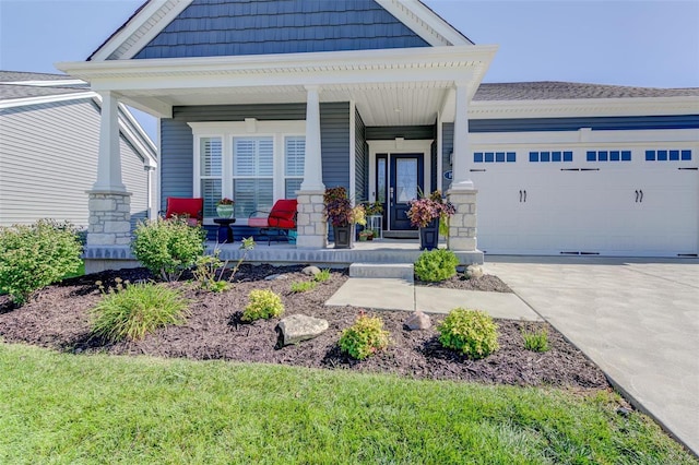 view of front of home featuring driveway, a garage, and a porch