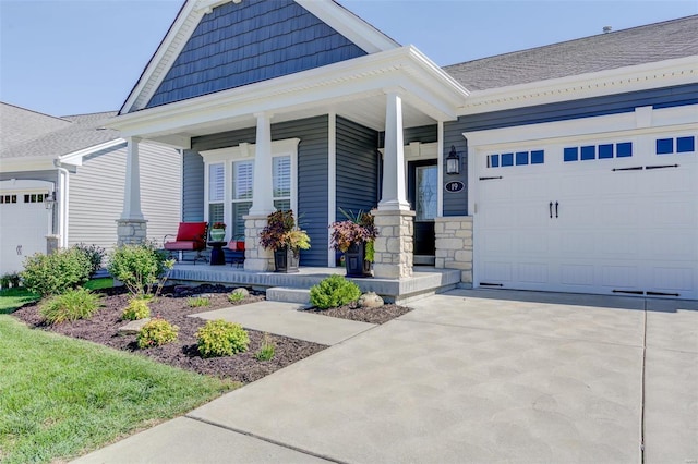 view of front of property with a garage, driveway, and a porch