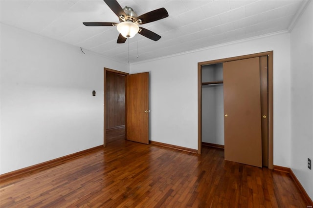 unfurnished bedroom with a closet, baseboards, and hardwood / wood-style floors