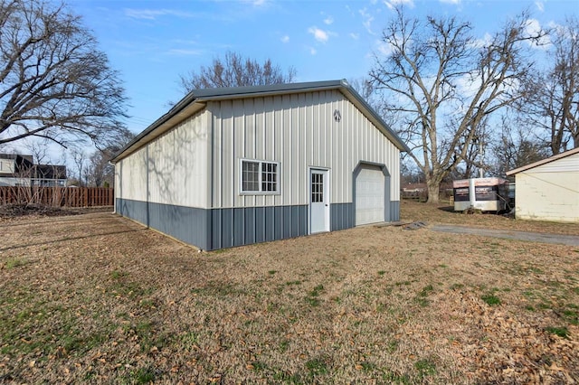 view of outbuilding featuring an outbuilding and fence