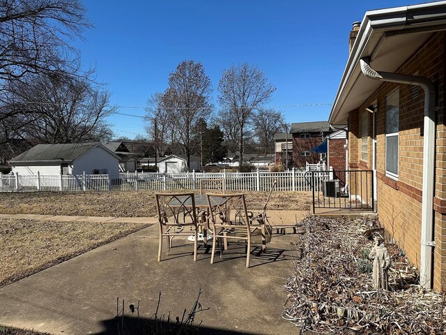 view of yard featuring a fenced backyard, central air condition unit, outdoor dining area, and a patio