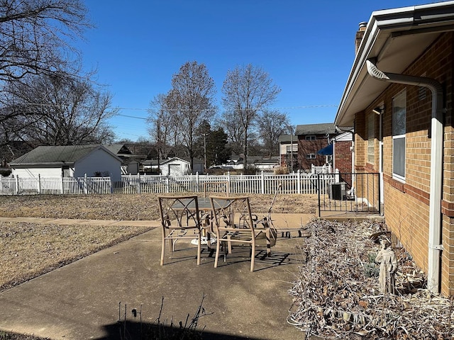 view of yard featuring a patio area, cooling unit, outdoor dining area, and a fenced backyard