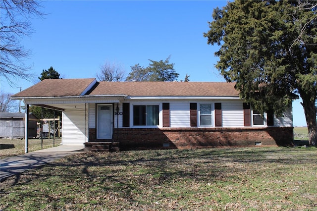 ranch-style home featuring brick siding, crawl space, a front lawn, and an attached carport