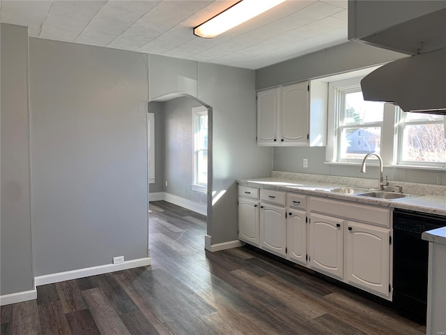 kitchen featuring arched walkways, a sink, white cabinetry, black dishwasher, and dark wood-style floors