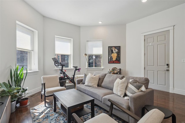 living room with visible vents, baseboards, wood finished floors, and recessed lighting