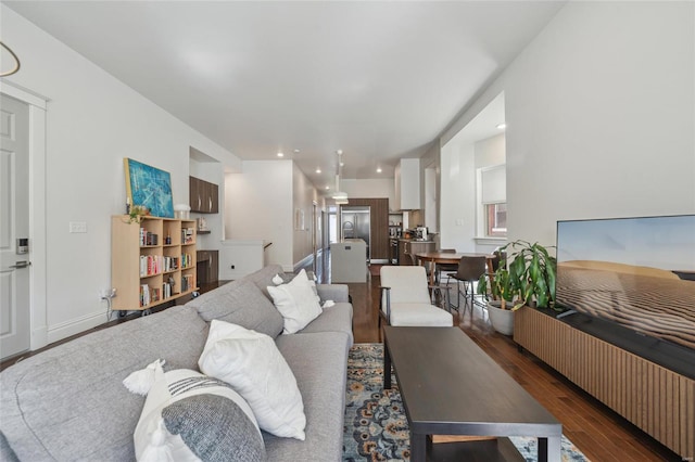 living room with recessed lighting, baseboards, and wood finished floors