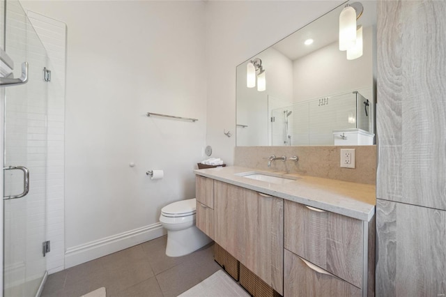 full bathroom featuring a stall shower, baseboards, toilet, tile patterned flooring, and vanity