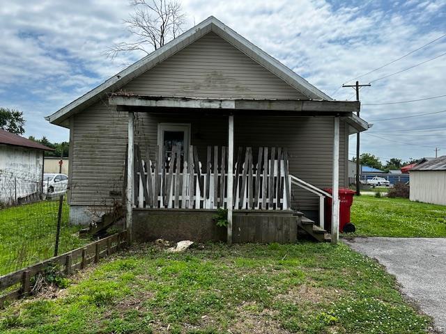 bungalow with a porch and a front yard