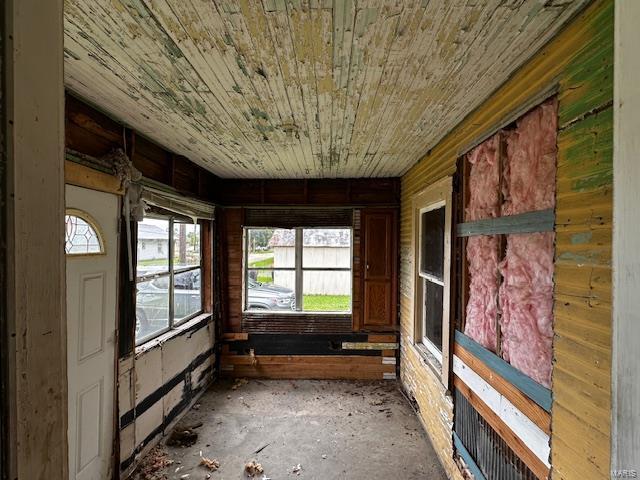 unfurnished sunroom featuring wood ceiling