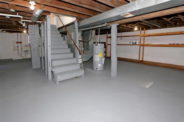 unfinished below grade area with water heater, stairway, and a sink