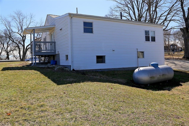 view of side of home featuring a lawn