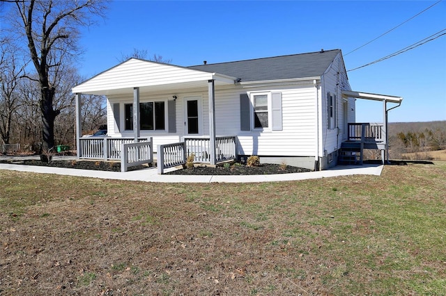 view of front of house with a porch and a front lawn