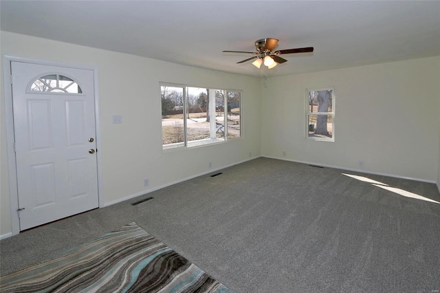 carpeted entrance foyer with baseboards and visible vents