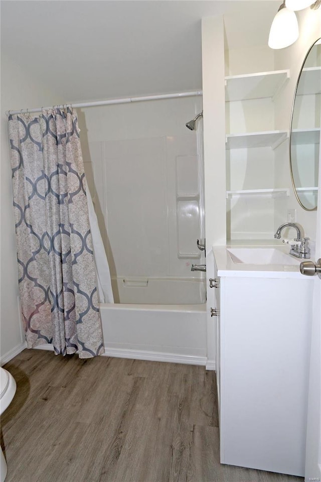 full bath with shower / bath combo with shower curtain, wood finished floors, and vanity