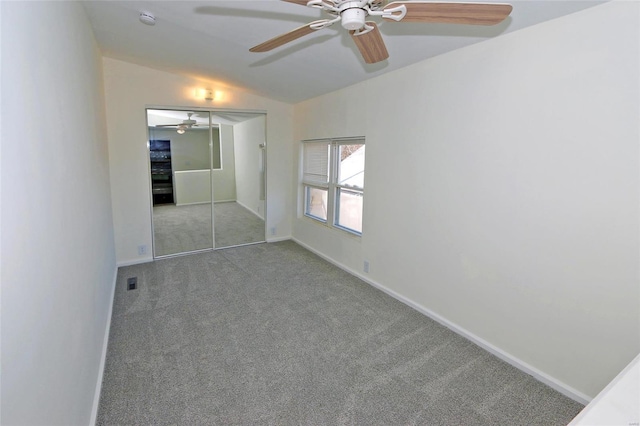 unfurnished bedroom featuring visible vents, baseboards, vaulted ceiling, carpet flooring, and a closet