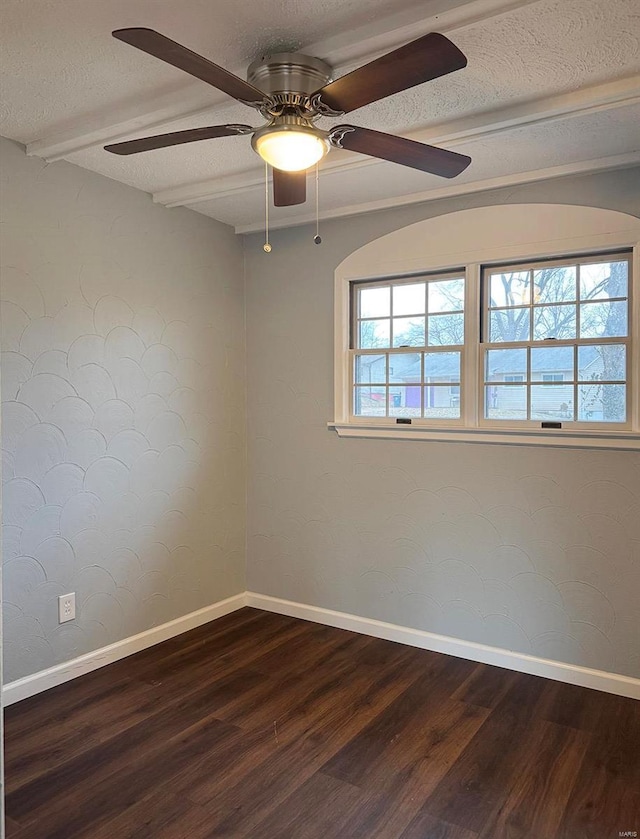 spare room featuring a textured ceiling, baseboards, and wood finished floors