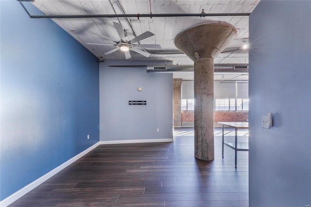 empty room with ceiling fan, wood finished floors, visible vents, and baseboards