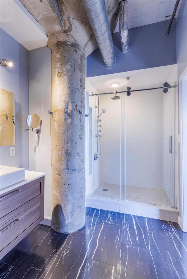 bathroom featuring a shower stall and vanity