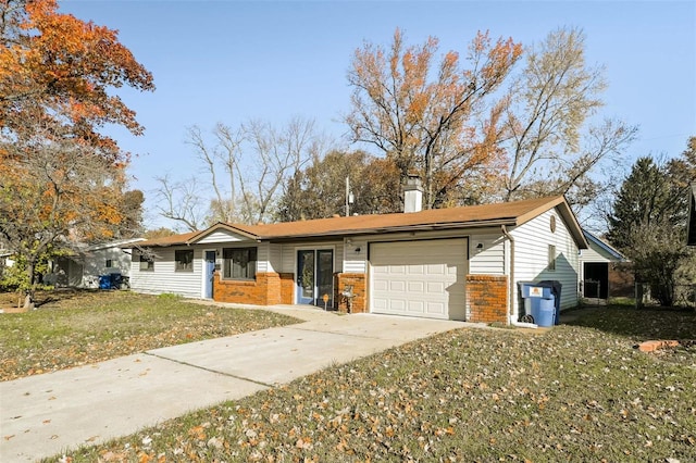 single story home featuring brick siding, concrete driveway, a chimney, an attached garage, and a front yard