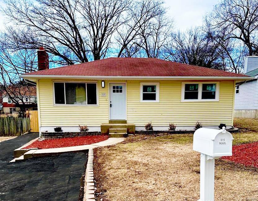 bungalow-style house featuring entry steps, a chimney, and fence