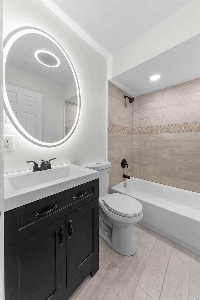 bathroom with vanity, toilet, bathing tub / shower combination, and wood finish floors