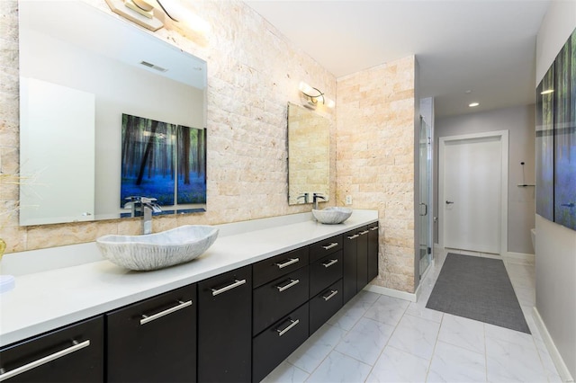 full bath featuring marble finish floor, visible vents, a sink, and double vanity