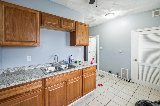 kitchen featuring light countertops, a sink, and visible vents