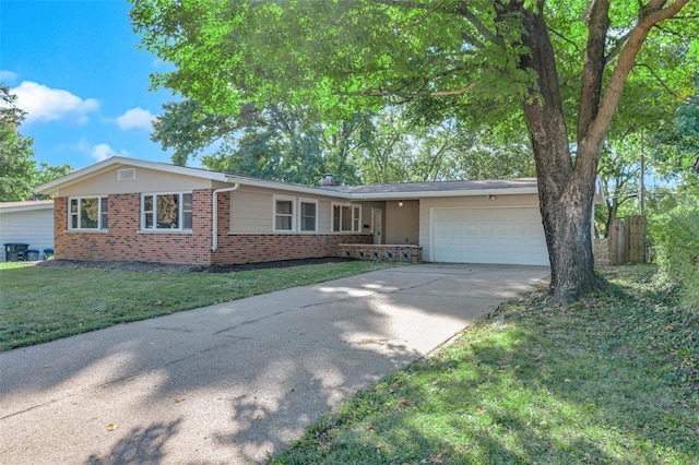 single story home with driveway, brick siding, an attached garage, and a front yard