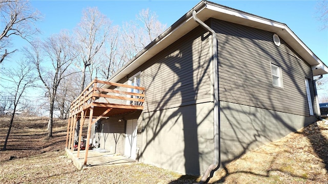 view of property exterior featuring a wooden deck