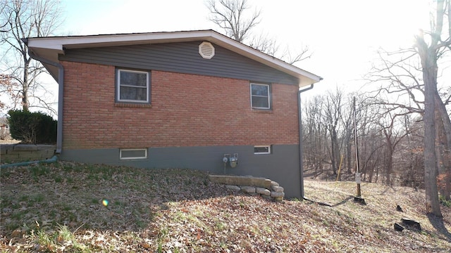 view of property exterior featuring brick siding