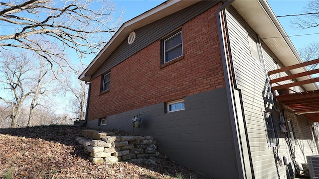 view of side of home featuring brick siding